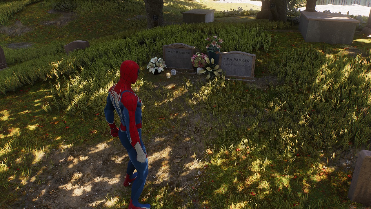 There is a shot of Uncle Ben and Aunt May's grave. Spider-Man is standing above the grave.