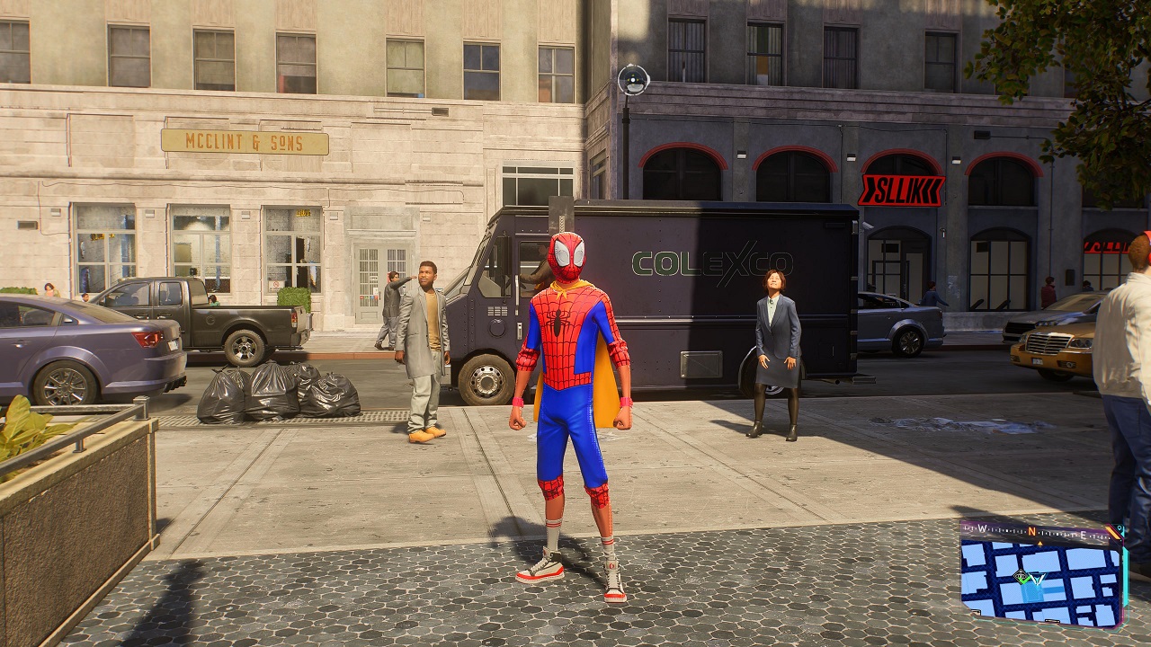 There is an image of Miles Morales standing on the New York City sidewalk. He is wearing a suit with a short yellow cape.