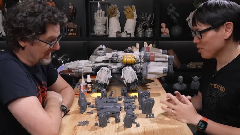 Tested 3D modeler Sean Charlesworth sitting alongside a co-host with all the pieces for the Froentier model freshly 3D printed.