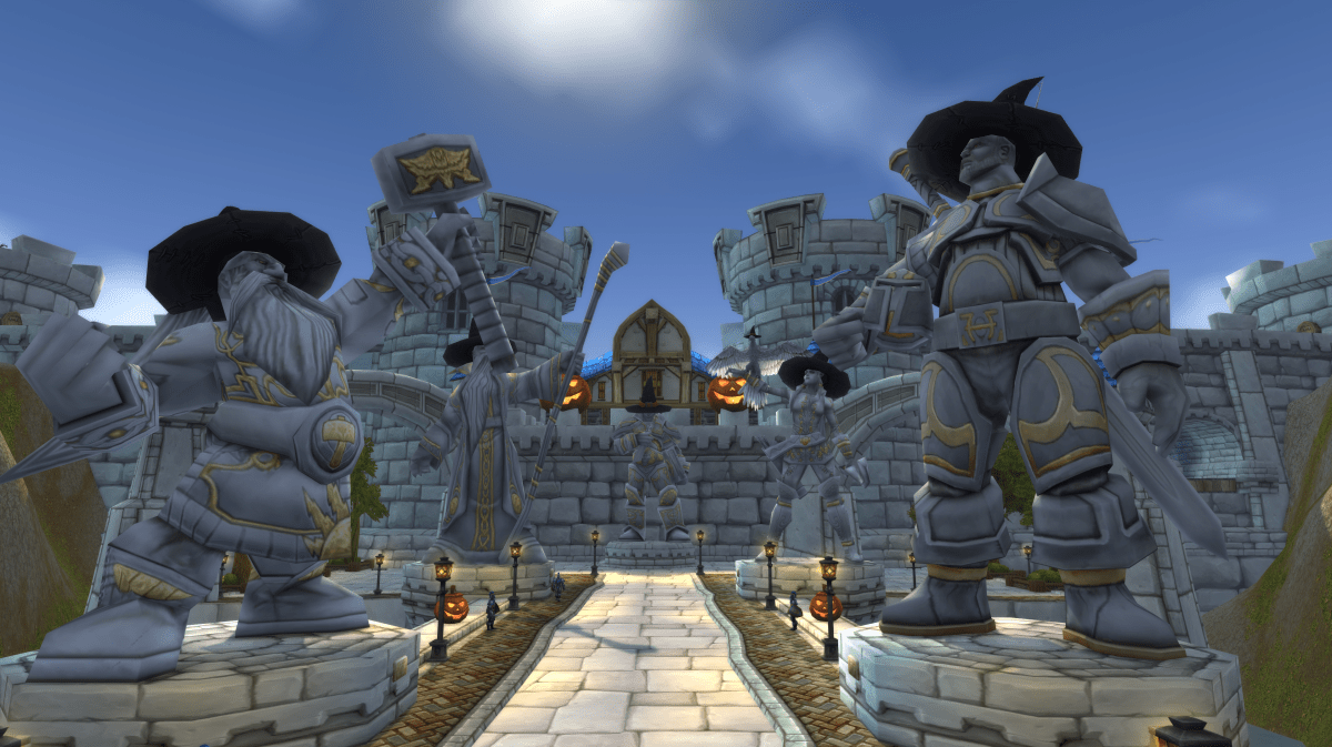 Stormwind City's entrance in World of Warcraft, decorated for Hallow's End. The statues in front of the city are all wearing pointed black hats.