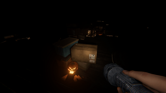 A pumpkin sitting by some boxes.