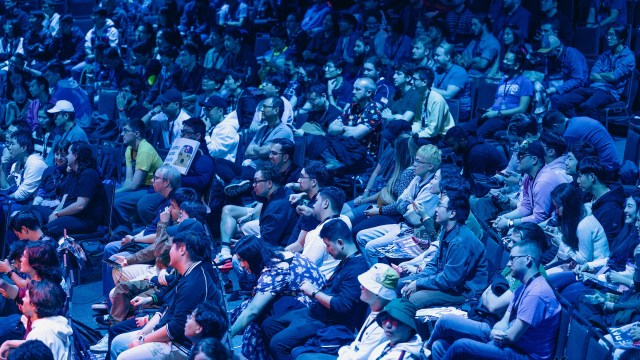 A crowd cheers and celebrates in Seattle at The Road to The International, a Dota 2 tournament.