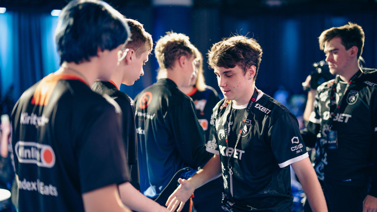 Team Spirit players shake hands with Virtus Pro players at TI 2023.