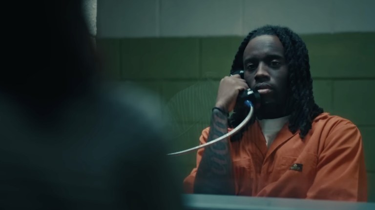 Kai Cenat on the phone in prison during the stream trailer.