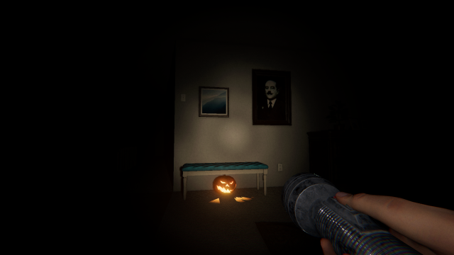 A pumpkin underneath a bench in the kitchen.
