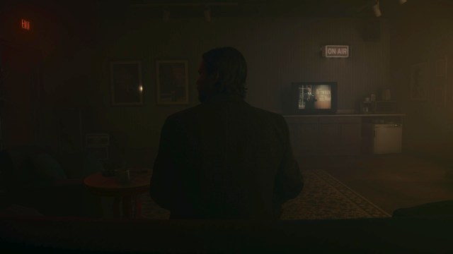 AW2: Alan Wake sitting in front of tv with talk show playing