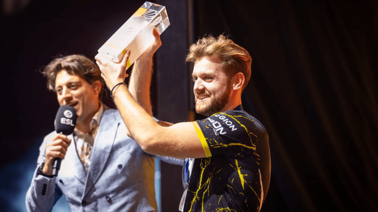 Niko on stage at ESL event holding a trophy