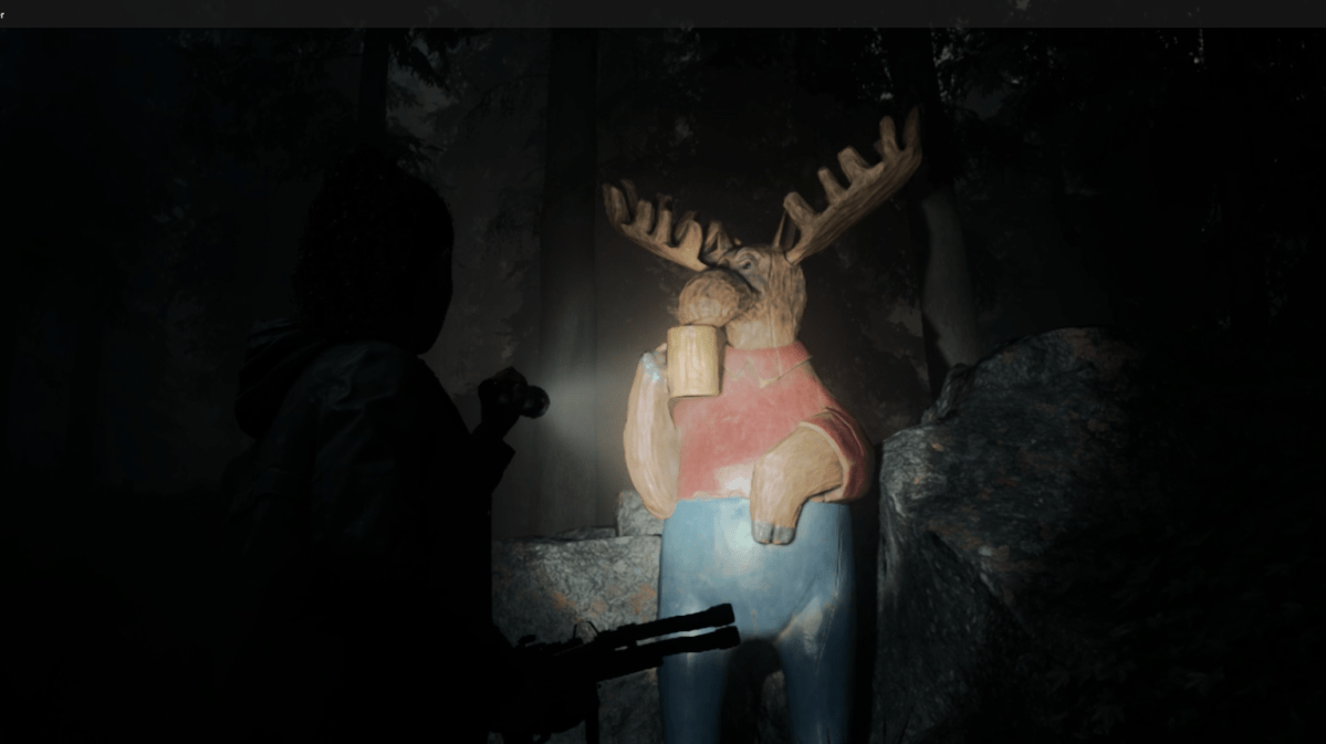 Saga shining her flashlight at a moose statue in the woods at night in Alan Wake 2.