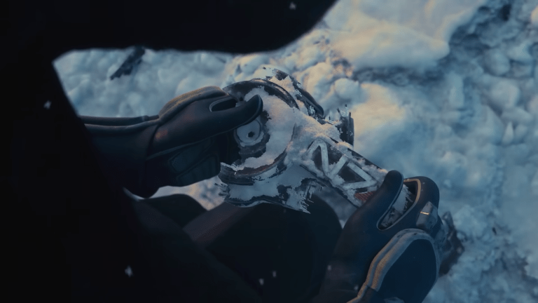 Mass Effect N7 Armor pulled out of the snow in teaser trailer