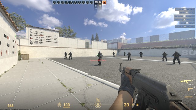 a cs2 player holding an ak at a bot