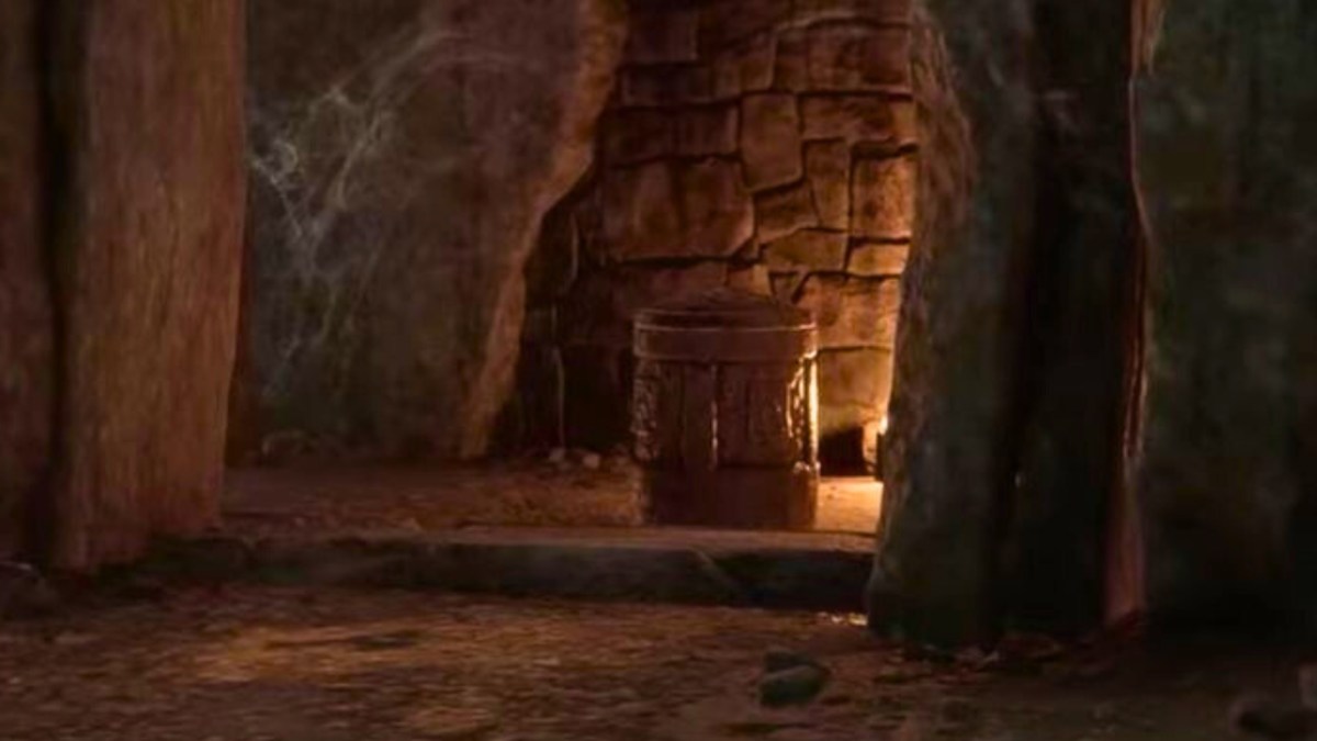 A cave with torches and a cylinder chest in hogwarts legacy