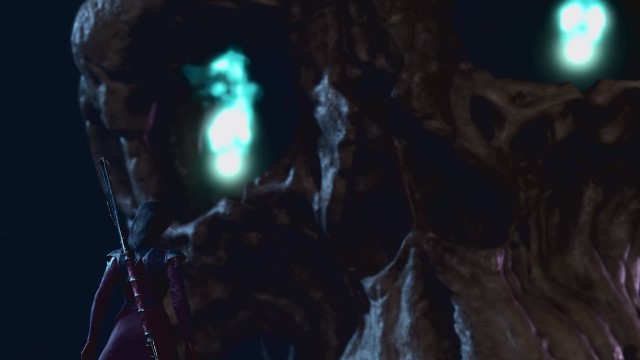 A massive skull approaches a character with a staff in BG3. The skull's eyes are glowing.