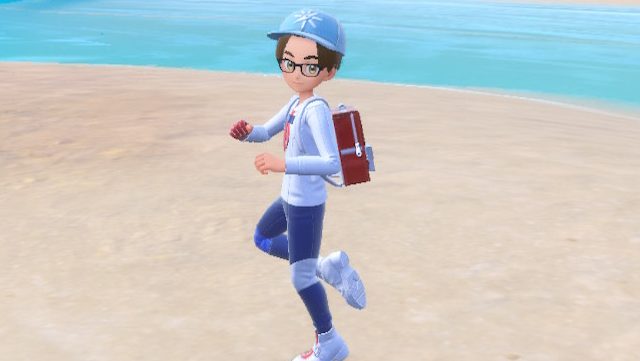 A boy spins on a foot on the beach of Pokémon Scarlet and Violet.