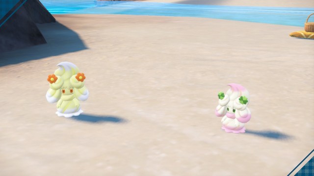 A pair of Alcremie stand on a beach in Pokémon Scarlet and Violet. Each Alcremie has a different type of Sweet.