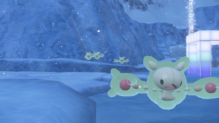 A group of Reuniclus float along the frozen terrain of Pokémon Scarlet and Violet.