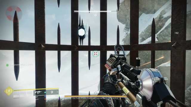 A player is looking through the bars of their metal cage at a floating Taken turret with a white, glowing core.