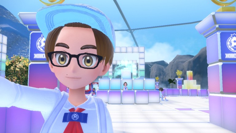 A boy in a hat stands in front of a pink and colorful but block-built entrance to the Fairy Elite Four in The Indigo Disk DLC of Pokemon Scarlet/Violet.