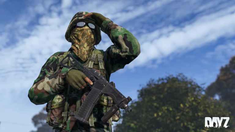 A soldier looking out to the horizon wearing camouflage.