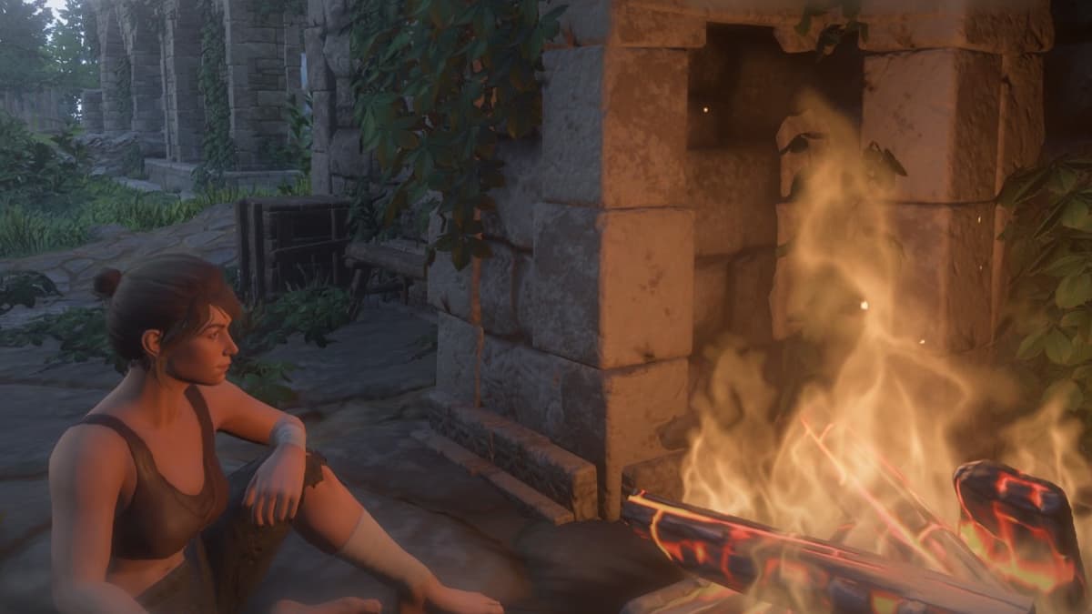The player sitting by a fire.