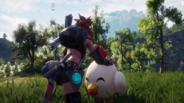 A player in Palworld petting a Chikipi.
