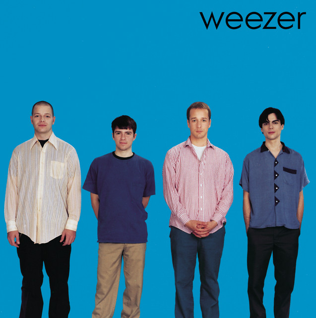 An image from Fortnite Festival of the Buddy Holly cover art, showing the band Weezer with a blue background. 