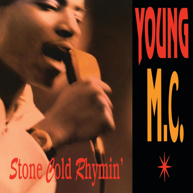 An image from Fortnite Festival of the Bust A Move cover art, which features the Young MC singing into an old microphone. 