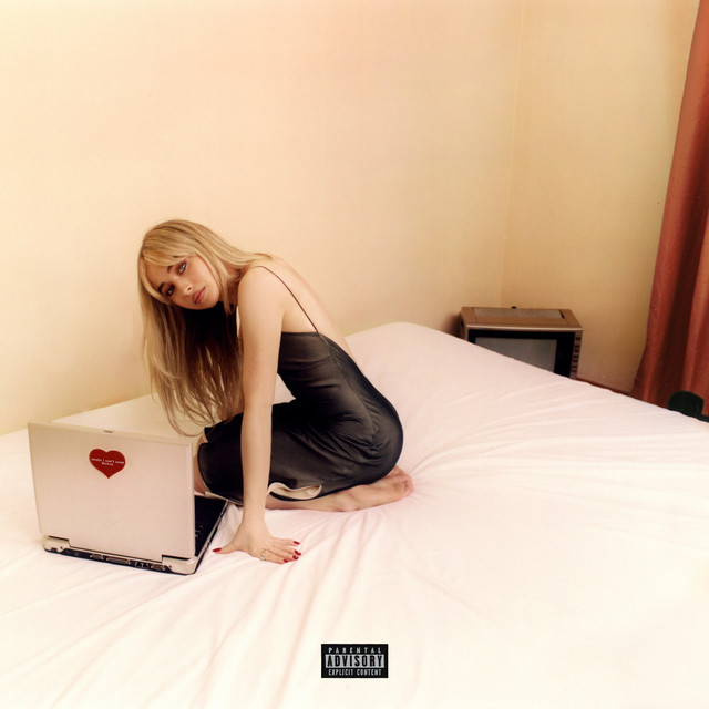 An image from Fortnite Festival of the Feather cover art. This features Sabrina Carpenter on a bed with a laptop. 