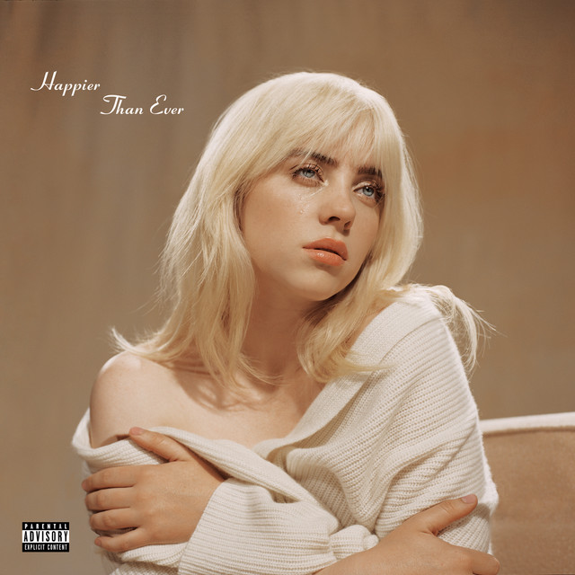 An image of the Happier than Ever cover art, a song in Fortnite Festival. This album art showcases Billie with blonde hair in a white shirt. 