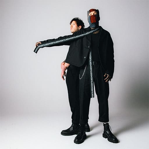 An image from Fortnite Festival of the Heathens cover art, which features two men in black outfits posing. 