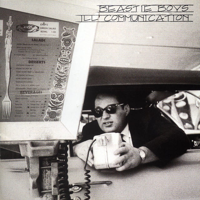 An image of the cover art to Sabotage, a song by the Beastie Boys in Fortnite Festival .This cover art features a man with a box peaking out his car. 