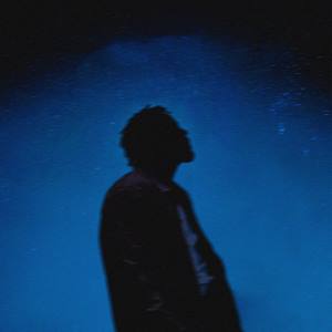 An image from Fortnite Festival of the Stargazing cover art. This features a silhoutte of a man against a dark blue sky. 