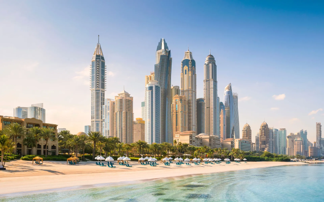 The One&Only Royal Mirage Resort in front of the skyline of Dubai, UAE.