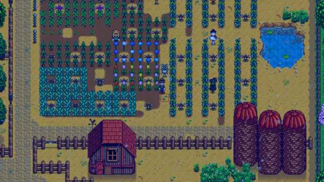 Stardew Valley character is standing in the field with many sprinklers