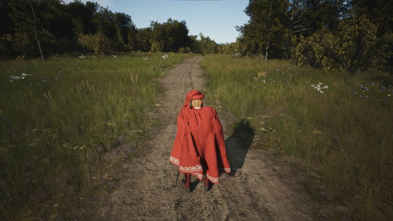 Man in a cloak standing in the middle of an old road.