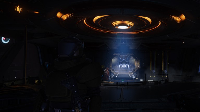 A Helldiver in heavy armor stares outside while standing at the bridge of a ship.