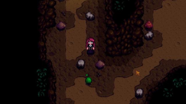 The player standing near a Slime in the Mines in Stardew Valley.