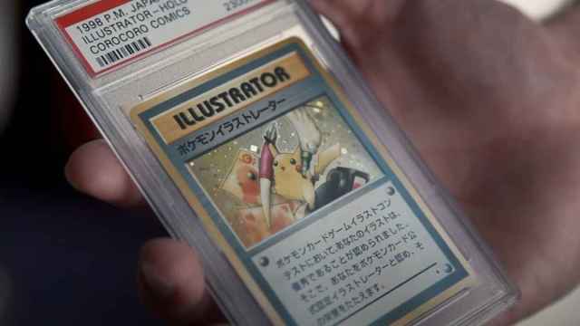 Logan Paul holding a graded Illustrator Pikachu card.