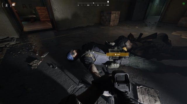 A dead LLA commander in a blue bandanna lies on the floor of a bunker in Gray Zone Warfare.