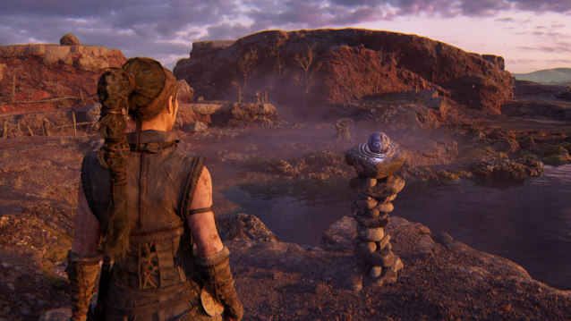 Senua looks at a sphere in a pedestal puzzle