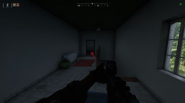 A player stands in a room in Gray Zone Warfare with a red arrow pointing to the location of a mission objective.