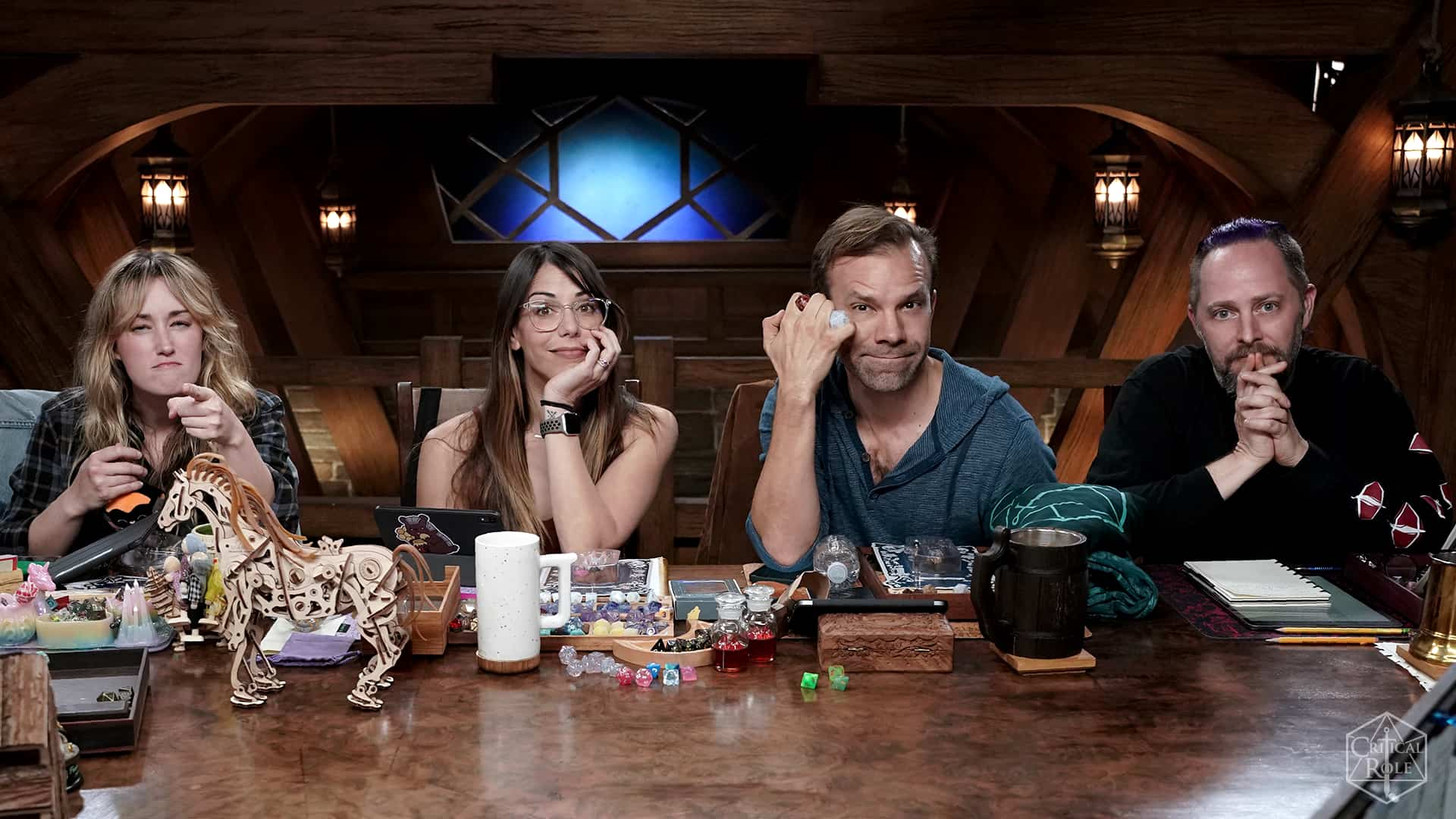 An image of Ashley Johnson, Laura Bailey, Liam O'Brien, and Taliesin Jaffe at the Critical Role table.