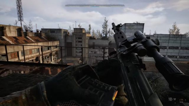 Reloading a sniper rifle on a rooftop overlooking derelict buildings in STALKER 2 trailer