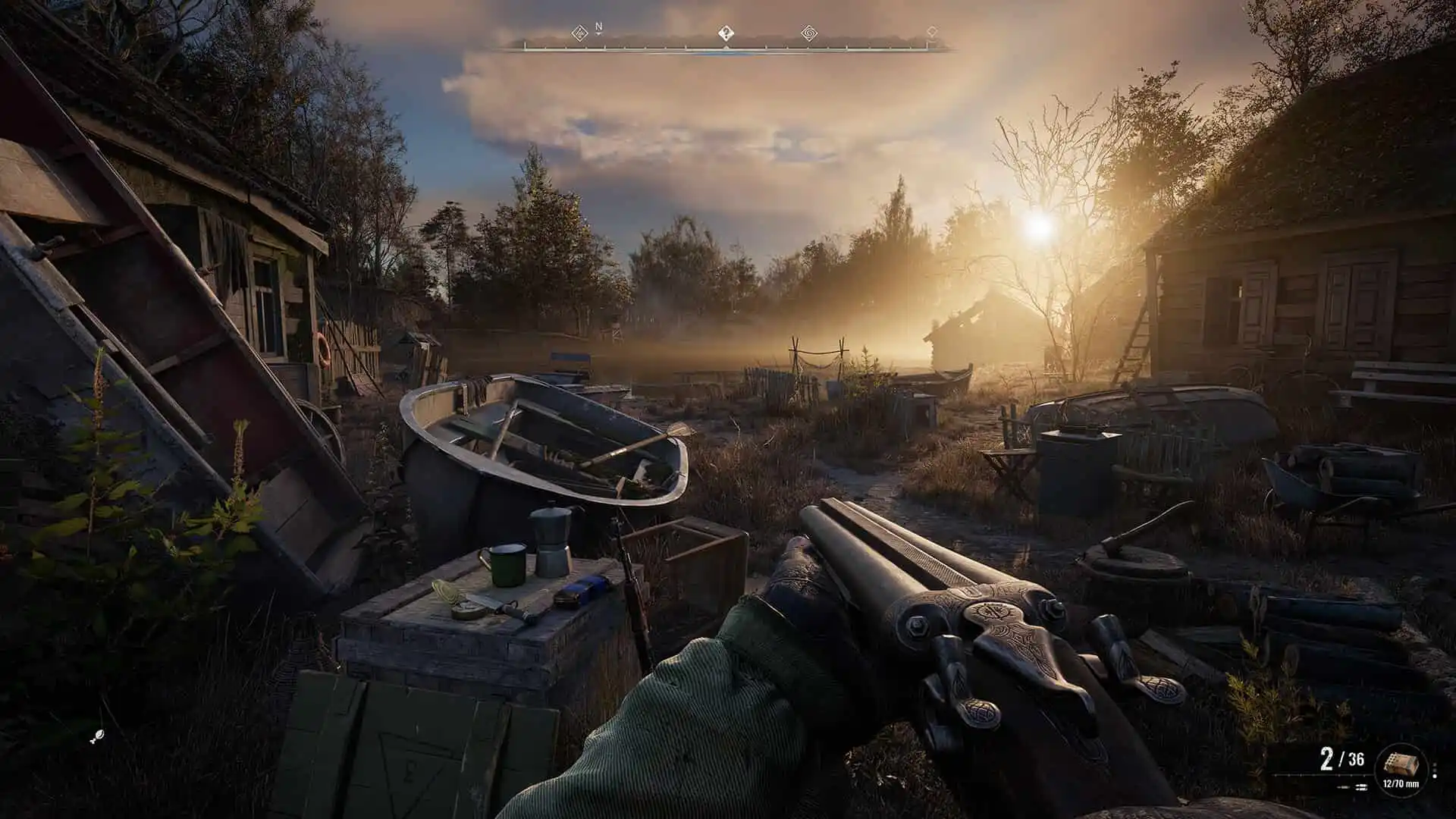 A character holding a shotgun looks out at a sunrise over a ruined and deserted town.