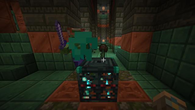 An Ominous Trial Key on top of a spawner in Minecraft.