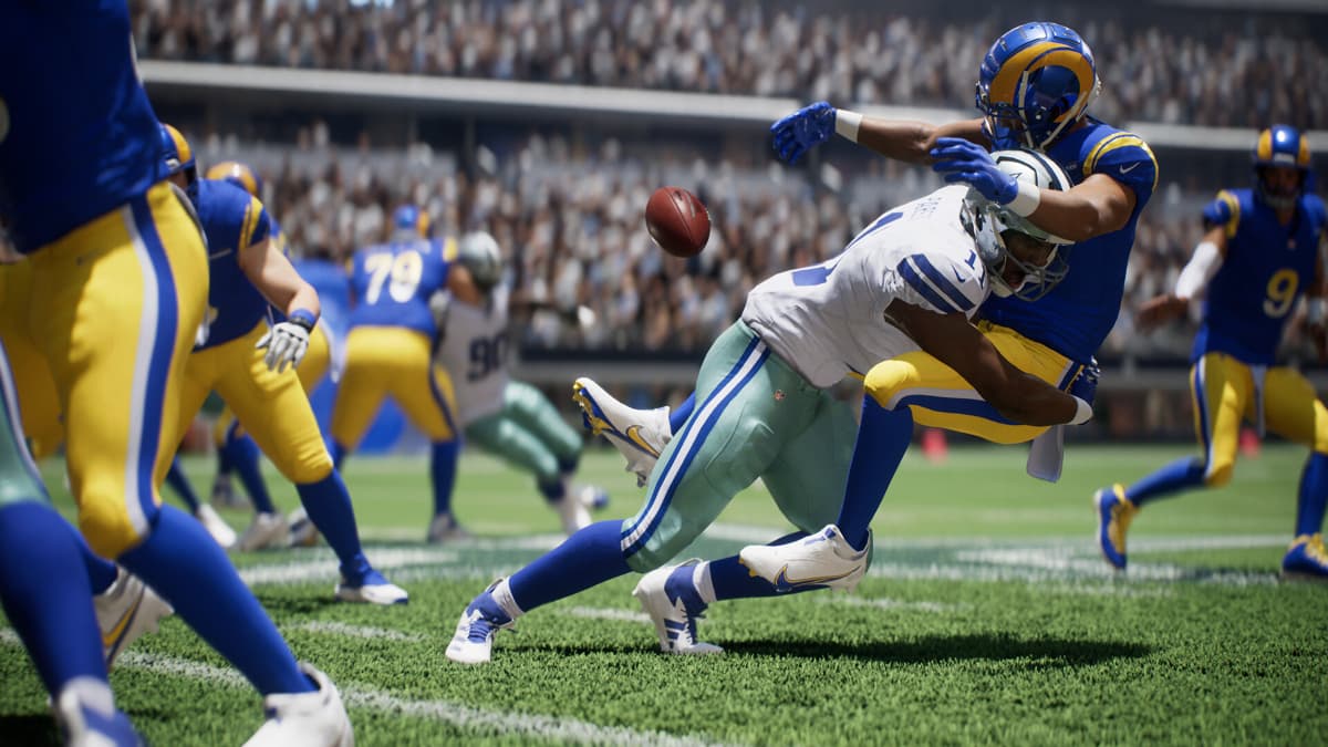 A Rams player in Madden 25 is tackled and loses possession of the ball.