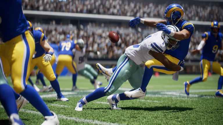 A Rams player in Madden 25 is tackled and loses possession of the ball.