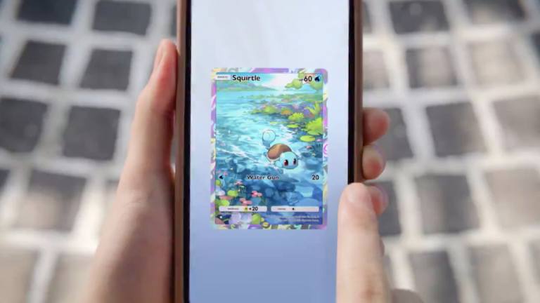 Someone holding a phone with a Squirtle card in TCG Pocket.