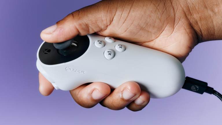 A player holding the new Xbox Adaptive Joystick.