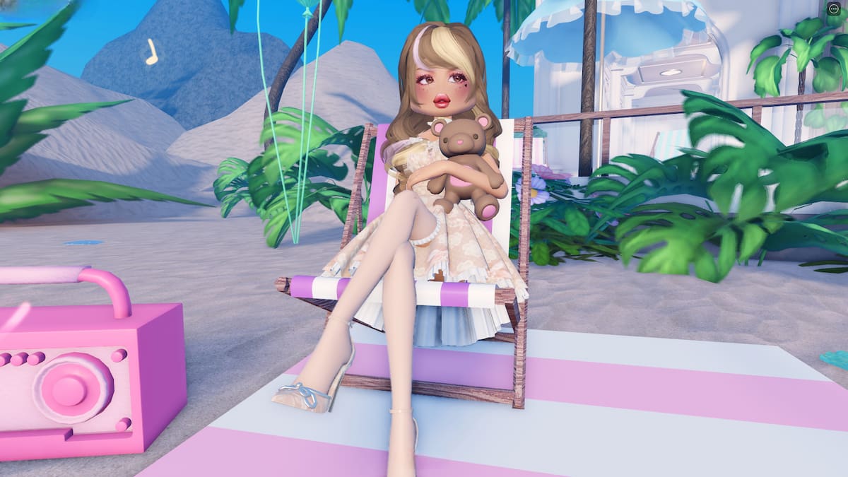 A character holding a teddy bear sitting on a chair in the beach in Roblox Dress To Impress.