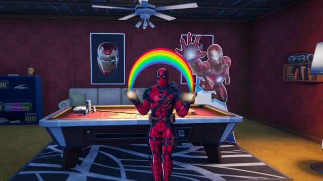 Deadpool holding a rainbow while standing in the secret Iron Man room in Fortnite.